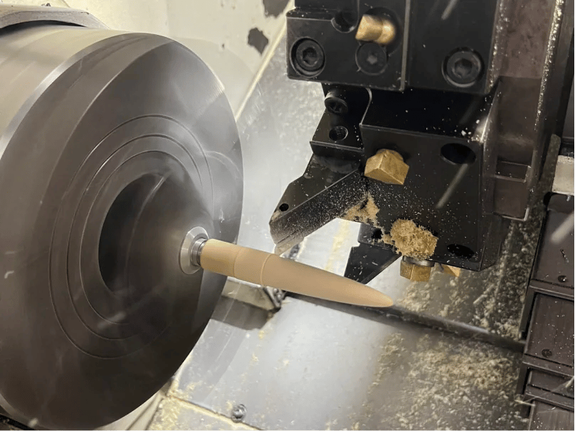 A craftsman turning an Aeon fountain pen body on a lathe