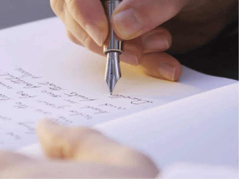 A hand writing with a bespoke Ashera fountain pen